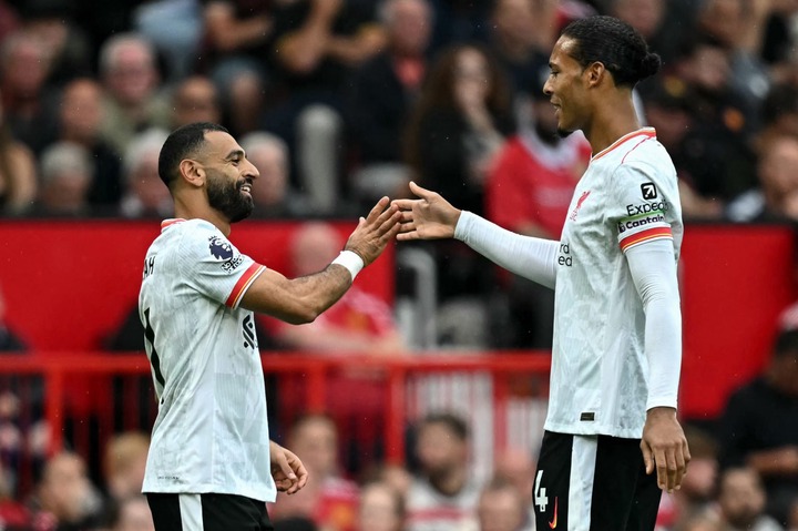 Liverpool's Egyptian striker #11 Mohamed Salah (L) celebrates with Liverpool's Dutch defender #04 Virgil van Dijk after scoring the team's third go...