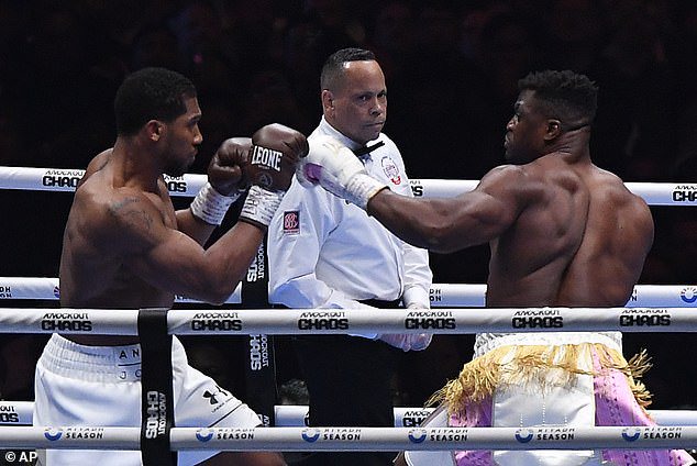 Ngannou was making his return to MMA after boxing fights against Anthony Joshua (pictured, left) and Tyson Fury over the last year