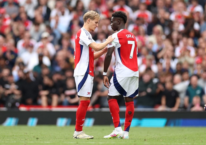 Martin Odegaard of Arsenal hands the Captains armband to Bukayo Saka of Arsenal during the Premier League match between Arsenal FC and Brighton &am...