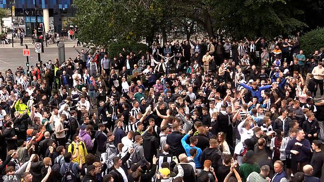 Jubilant Newcastle United fans celebrate the club's Saudi takeover outside the stadium