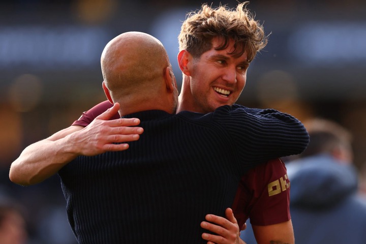 John Stones of Manchester City celebrates 1-2 win with Pep Guardiola during the Premier League match between Wolverhampton Wanderers FC and Manches...