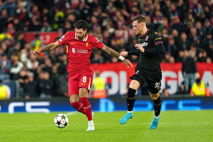 Liverpool's Dominik Szoboszlai is in action with Bologna's Sam Beukema during the UEFA Champions League match between Liverpool and Bologna FC 1909...