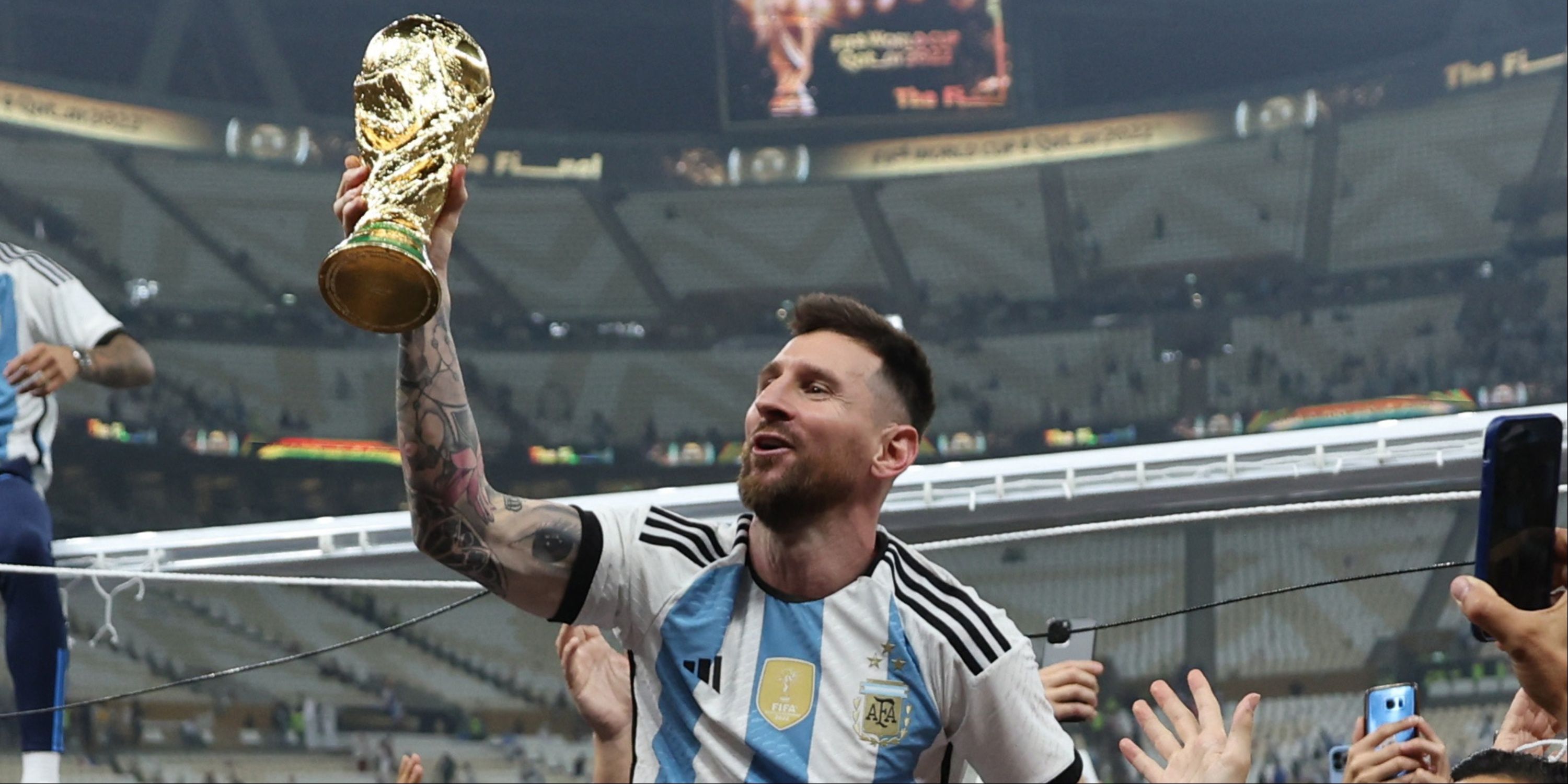 Lionel Messi with the World Cup trophy