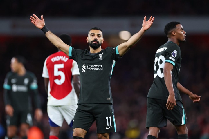 Mohamed Salah of Liverpool celebrates after scoring a goal to make it 2-2 during the Premier League match between Arsenal FC and Liverpool FC at Em...