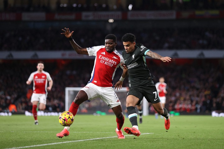 Luis Diaz of Liverpool takes on Thomas Partey of Arsenal during the Premier League match between Arsenal FC and Liverpool FC at Emirates Stadium on...