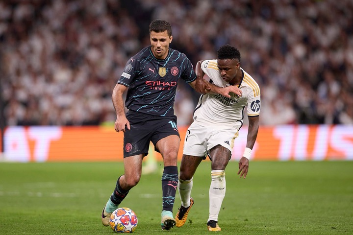 Rodrigo Hernandez Cascante, known as Rodri (L) of Manchester City with Vinicius Junior (R) of Real Madrid CF in action during the UEFA Champions Le...