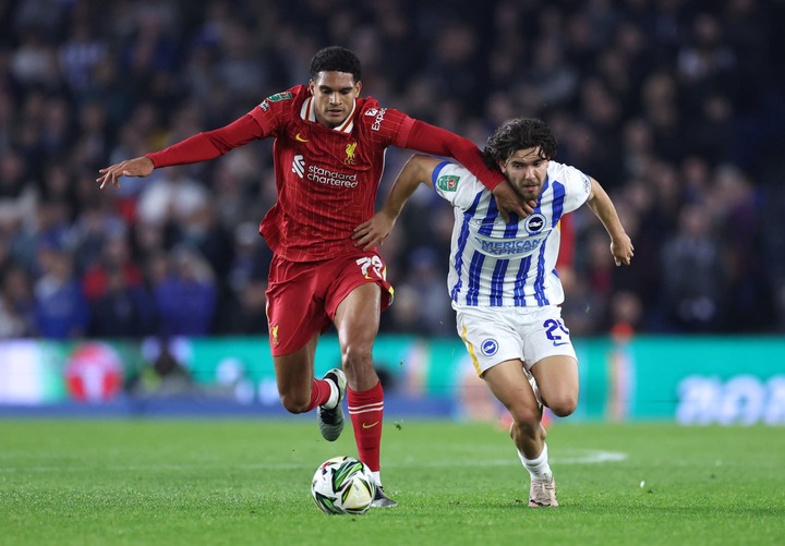 Jarell Quansah of Liverpool is challenged by Ferdi Kadioglu of Brighton & Hove Albion during the Carabao Cup Fourth Round match between Brighto...