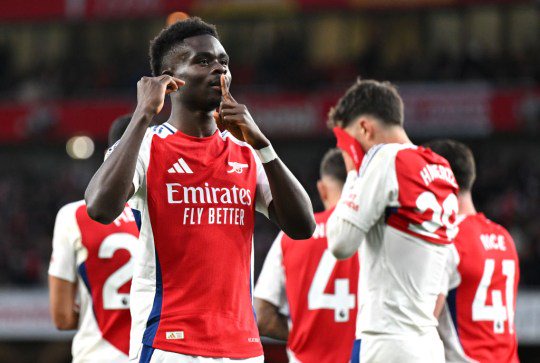 Bukayo Saka of Arsenal celebrates scoring his team's first goal during the Premier League match between Arsenal FC and Liverpool FC at Emirates Stadium 