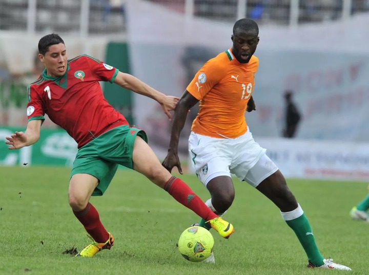 Morocco's Aziz Abdel Barrada (L) vies with Ivory Coast's Yaya Toure