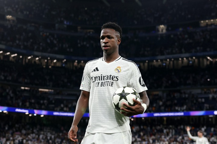 Vinicius Junior of Real Madrid collects the match ball at full-time having scored a hat-trick following the team's victory in the UEFA Champions Le...