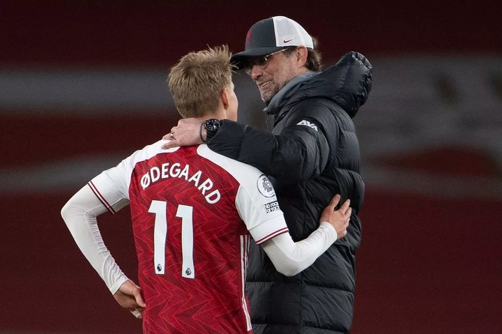 Martin Odegaard of Arsenal and Liverpool Manager Jurgen Klopp chat after the Premier League match between Arsenal and Liverpool at Emirates Stadium on April 03, 2021 in London, England.