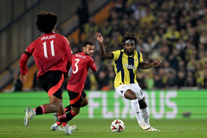 Fenerbahce's French forward #97 Allan Saint-Maximin fights for the ball with Manchester United's Dutch forward #11 Joshua Zirkzee and Manchester Un...