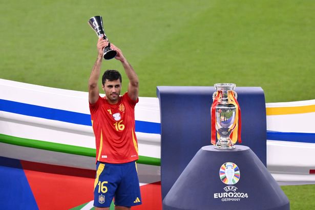 BERLIN, GERMANY - JULY 14: Rodri of Spain celebrates with his Player of the Tournament award after the UEFA EURO 2024 final match between Spain and England at Olympiastadion on July 14, 2024 in Berlin, Germany. (Photo by Oliver Hardt - UEFA/UEFA via Getty Images)