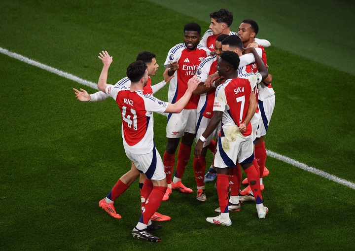 Mikel Merino of Arsenal celebrates with teammates after scoring his team's second goal during the Premier League match between Arsenal FC and Liver...