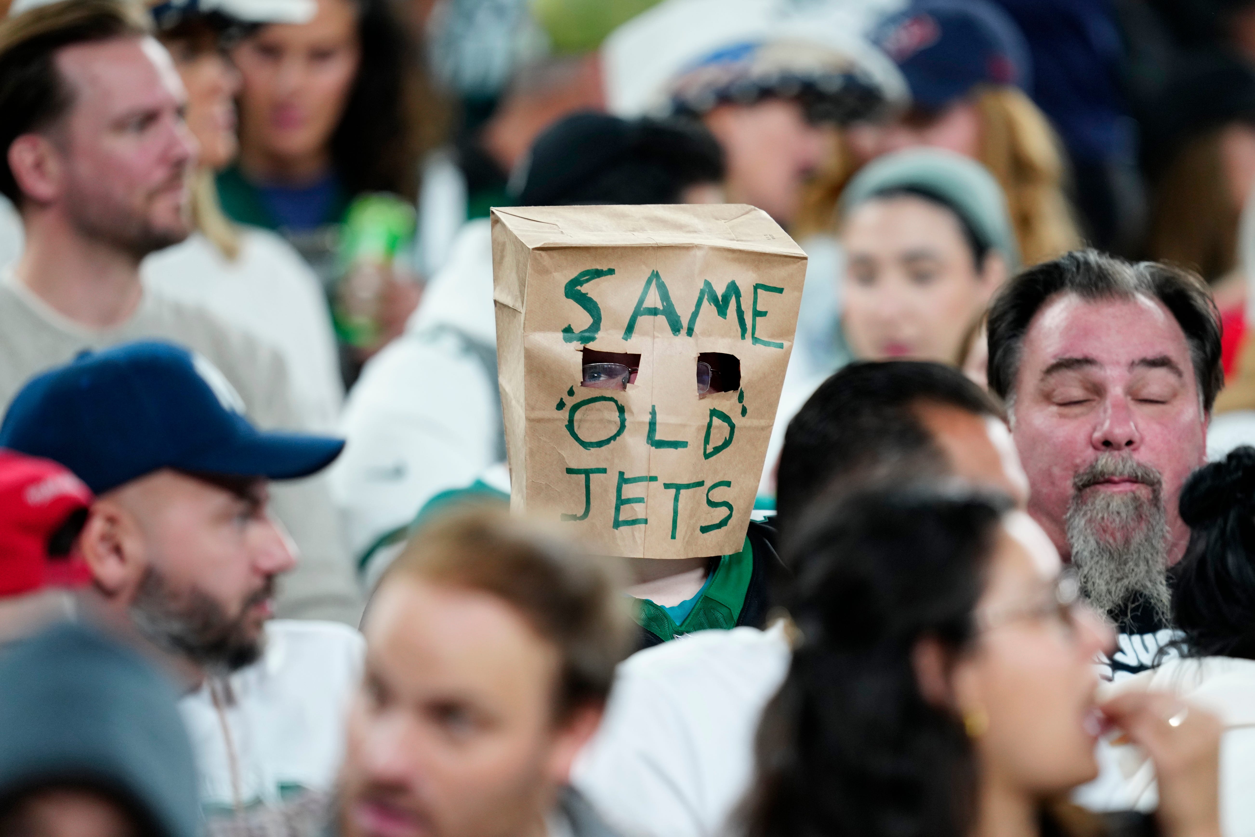 A New York Jets fan wears a paper bag over his face at MetLife Stadium, Thursday, October 31, 2024, in East Rutherford.