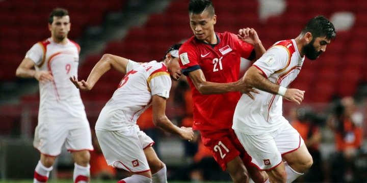 Ahmad Al Saleh (right) in action for Syria against Singapore