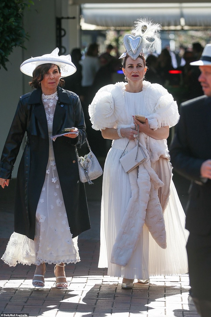 Other revellers worse elaborate hats and textured gowns for the prestigious event