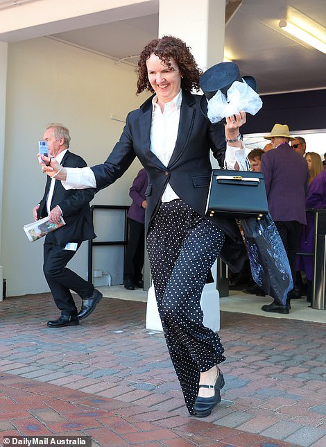 This woman wore a black blazer and accessorised with a top hat