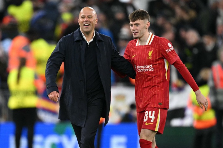 Liverpool's Dutch manager Arne Slot and Liverpool's Northern Irish defender #84 Conor Bradley celebrates after the UEFA Champions League football m...