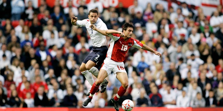 Austria's Sanel Kuljic battles with England's Lee Young for the ball