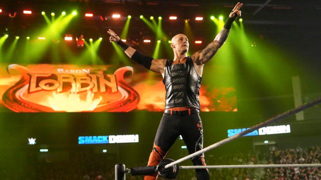 WWE superstar Baron Corbin poses on the middle rope during his SmackDown entrance