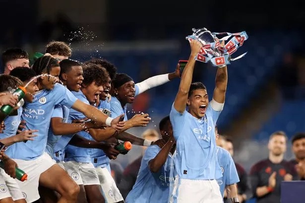 MANCHESTER, ENGLAND - MAY 10: Jahmai Simpson-Pusey of Manchester City lifts the FA Youth Cup trophy following victory in the FA Youth Cup Final match between Manchester City and Leeds United at Etihad Stadium on May 10, 2024 in Manchester, England. (Photo by Charlotte Tattersall/Getty Images)