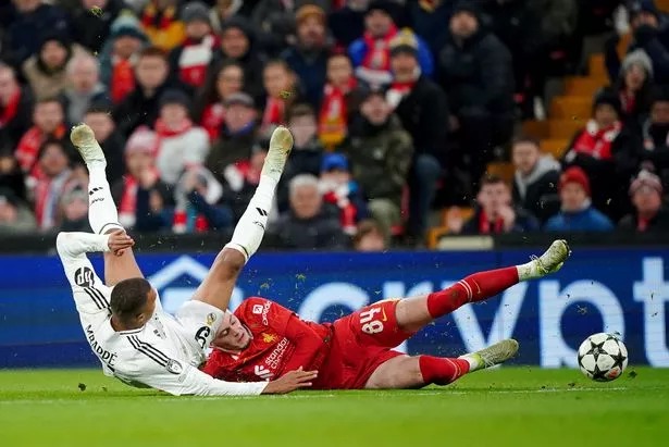 Liverpool's Conor Bradley (right) tackles Real Madrid's Kylian Mbappe during the UEFA Champions League, league stage match at Anfield, Liverpool.