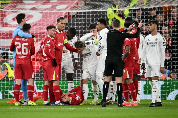 Liverpool's Uruguayan striker #09 Darwin Nunez hold his face whilst laying on the floor after an incident with Real Madrid's Spanish defender #35 R...