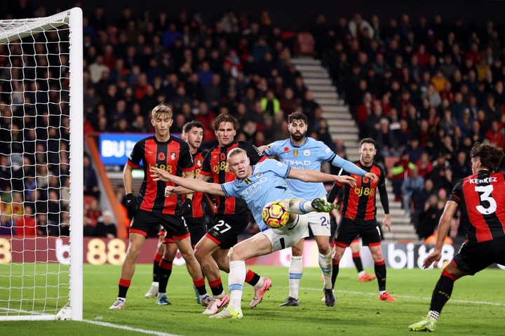 Erling Haaland of Manchester City shoots whilst under pressure from Illya Zabarnyi of AFC Bournemouth during the Premier League match between AFC B...