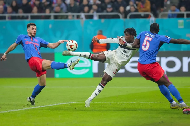 BUCHAREST, ROMANIA - JANUARY 30: Kobbie Mainoo (C) of Manchester United is seen after an acrobatic shot towards the goal during the UEFA Europa League 2024/25 League Phase MD8 match between Fotbal Club FCSB and Manchester United at National Arena Stadium on January 30, 2025 in Bucharest, Romania. (Photo by Vasile Mihai-Antonio/Getty Images)