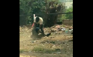 The soldier falls to the ground while in a fight with a civilian