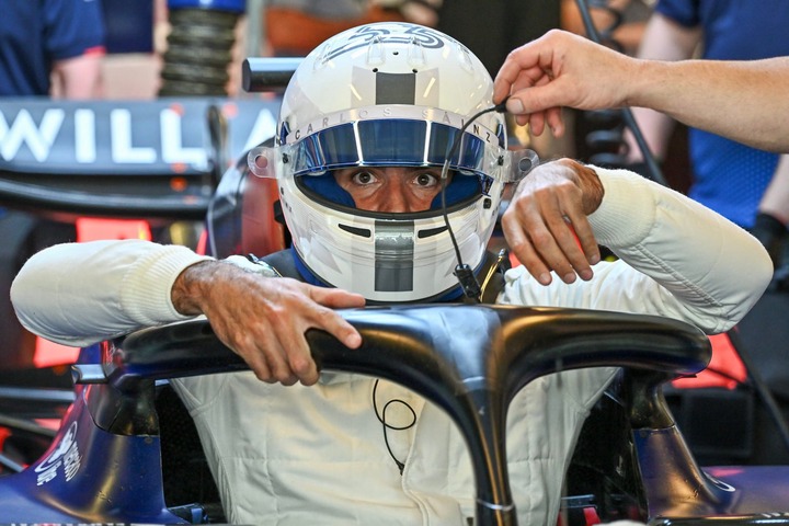 Carlos Sainz Jr of Spain gets into the (55) Williams Racing FW46 Mercedes in the garage during Formula 1 testing at Yas Marina Circuit on December ...