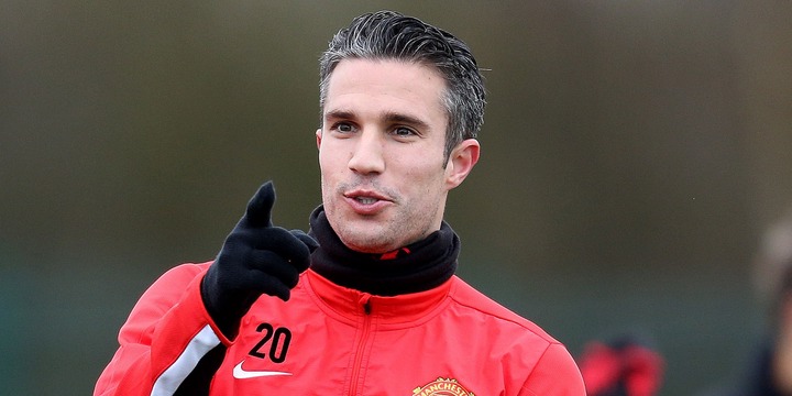 Robin van Persie smiles and points during Manchester United training session.