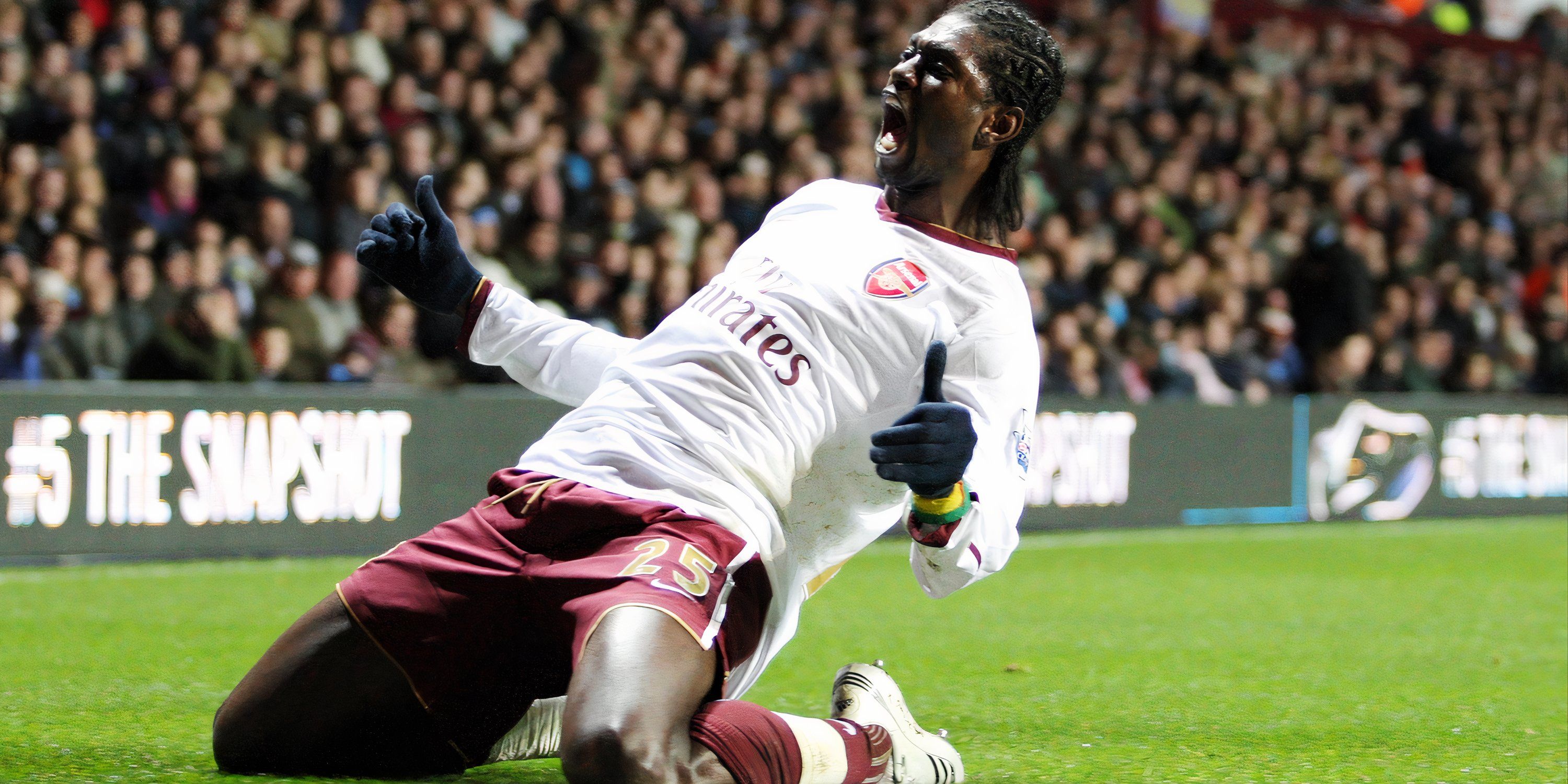 Emmanuel Adebayor slides to his knees in celebration after scoring for Arsenal.