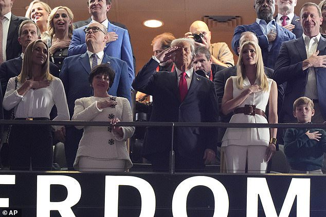 As Trump was photographed standing for the Star-Spangled Banner, his entourage for the Kansas City Chiefs-Philadelphia Eagles battle was clear