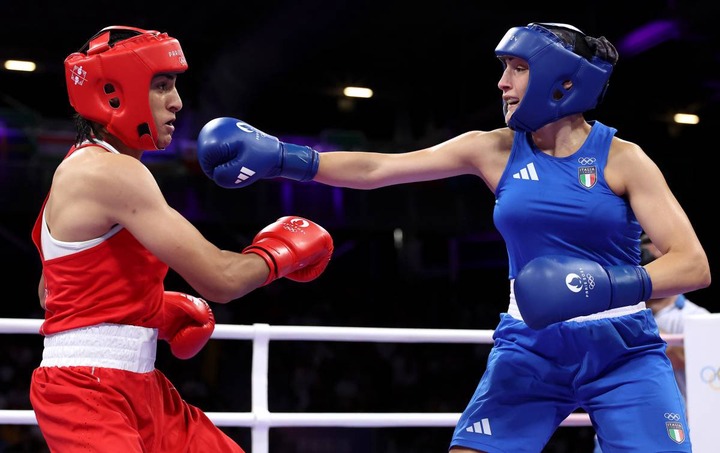 PARIS, FRANCE - AUGUST 01: Imane Khelif of Team Algeria dodges a punch from Angela Carini of Team Italy during the Women's. 66kg preliminary round match on day six of the Olympic Games Paris 2024 at North Paris Arena on August 01, 2024 in Paris, France. (Photo by Richard Pelham/Getty Images)