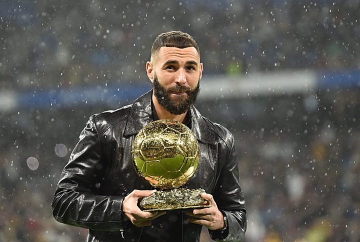 Karim Benzema of Real Madrid holds the Ballon d''Or award before the LaLiga Santander match between Real Madrid CF and Sevilla FC at Estadio Santia...