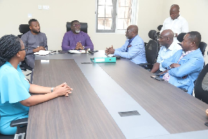 Dr. Andy Osei Okrah (M) in a meeting with staff of the Tree Crops Development Authority