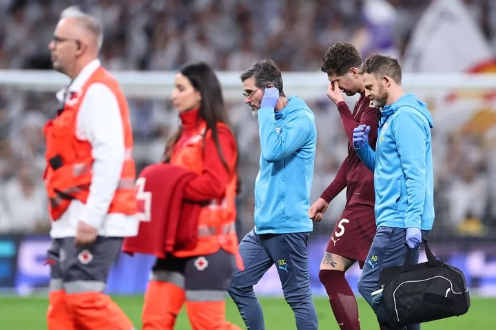 John Stones of Manchester City goes off injured during the UEFA Champions League 2024/25 League Knockout Play-off second leg match between Real Madrid and City 