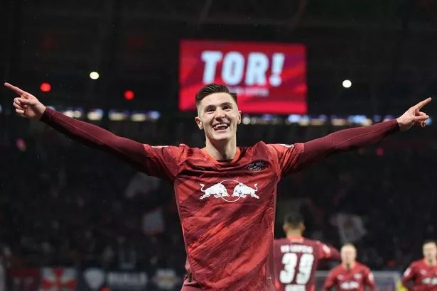 Leipzig's Slovenian forward #30 Benjamin Sesko celebrates scoring his team's first goal during the German first division Bundesliga football match between RB Leipzig and Eintracht Frankfurt