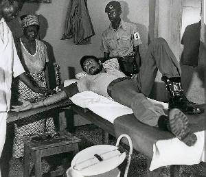 Flight Lieutenant Jerry John Rawlings donating blood during a national blood donation campaign