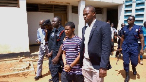 Daniel Asiedu being escorted by police officers