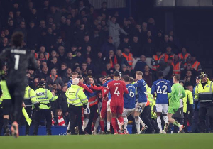 Players of Everton and Liverpool start a brawl at the end of the game