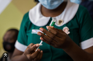 File photo of a health worker holding a syringe