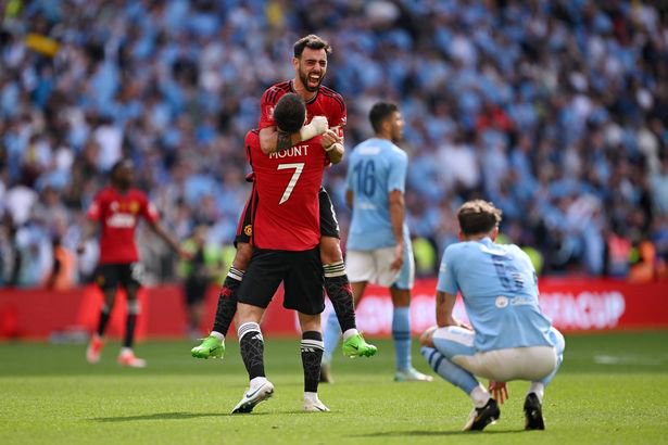 Bruno Fernandes and Mason Mount of Manchester United celebrate after the team's victory in the Emirates FA Cup Final match between Manchester City and Manchester United at Wembley Stadium