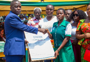 Member of Parliament for Bekwai, Ralph Poku-Adusei presenting a citation