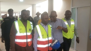 Health minister, Kwabena Mintah Akandoh [holding a helmet] on a tour of Agenda 111 projects