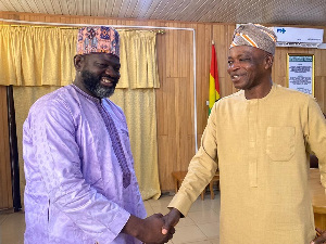 Northern Regional Minister Ali Adolf Mburidiba (R) in a handshake with Sheikh Dr. Abu Dujana Basha