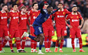 PSG player Dembele celebrating in front of Liverpool after the win